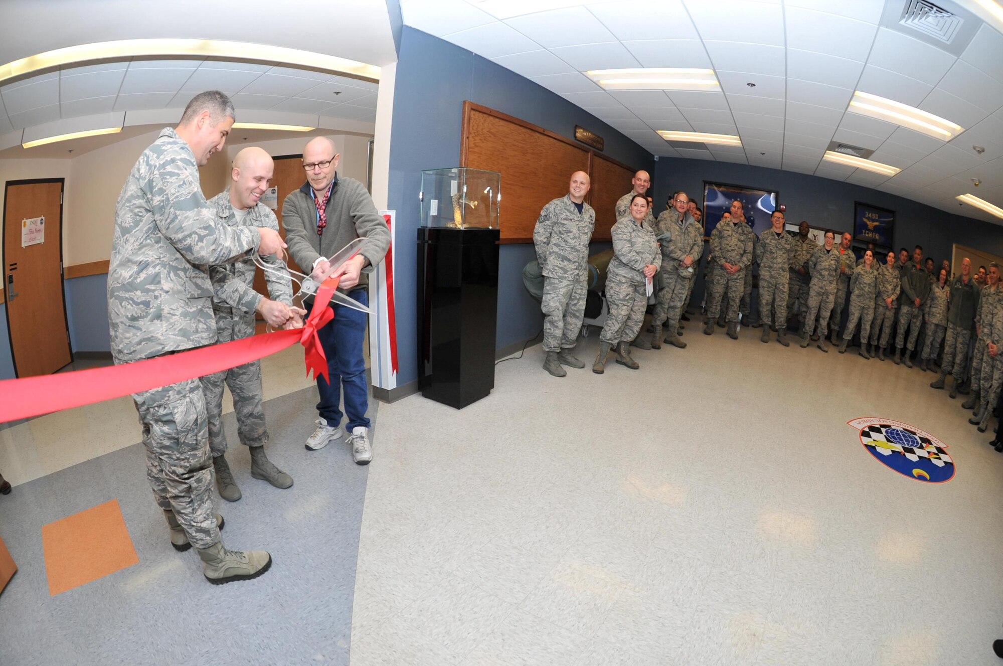 U.S. Air Force Lt. Col. Kenneth Stremmel, 315th Training Squadron Commander, Staff Sgt. Brittin Davis, 315th TRS instructor and John Blastick, 315th TRS facility manager, cut the ribbon officially opening the Heritage Hall in Di Tommaso Hall on Goodfellow Air Force Base, Texas, Jan. 6, 2017. Members worked together to create the hall to honor the units’ past. (U.S. Air Force photo by Staff Sgt. Laura R. McFarlane/Released)