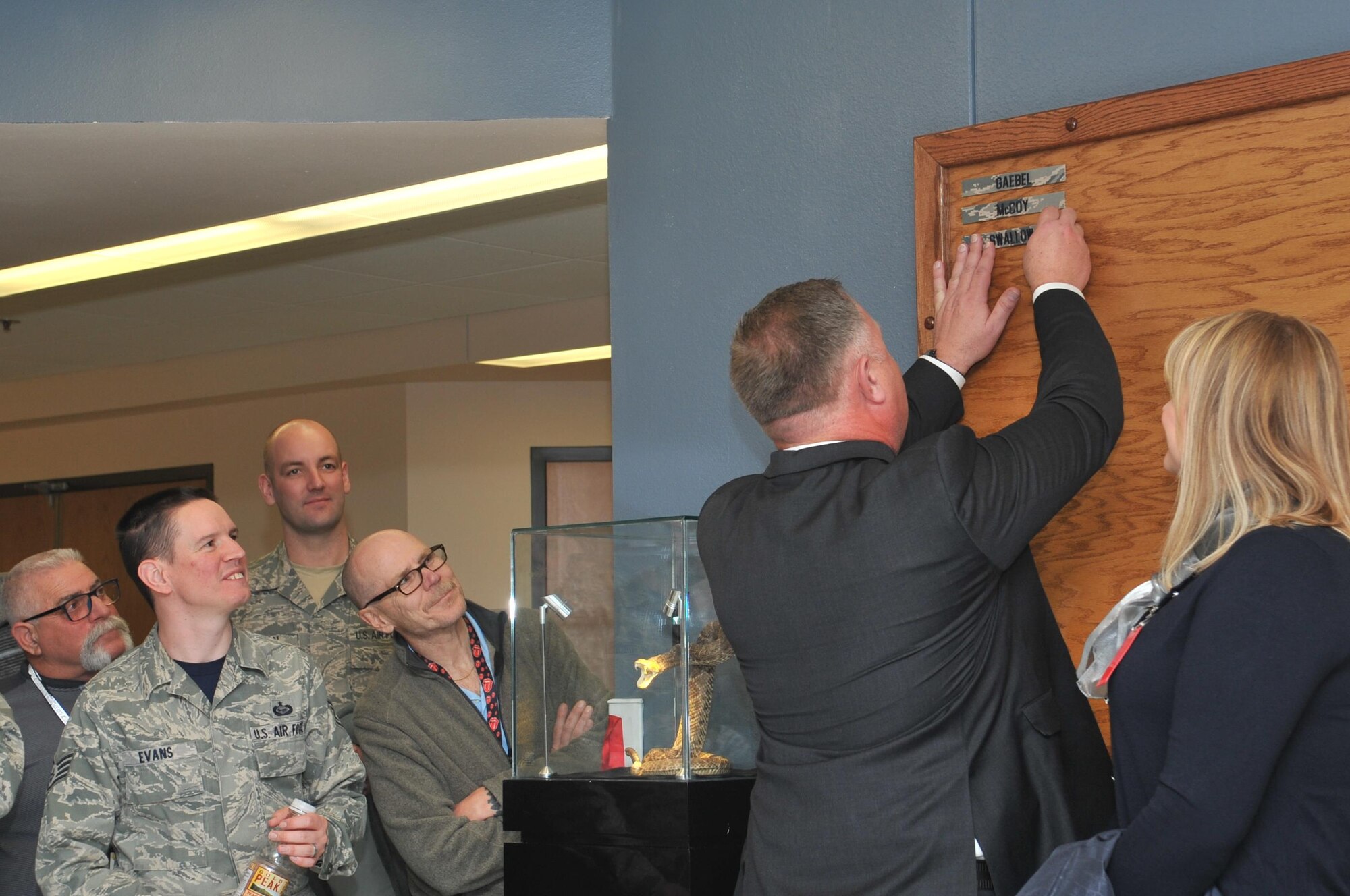 U.S. Air Force retired Lt. Col. Devin Swallow, former 315th Training Squadron Commander, places his nametag on the wall in Heritage Hall in Di Tommaso Hall on Goodfellow Air Force Base, Texas, Jan. 6, 2017. Departing personnel will place their nametags on the board as part of the heritage of the unit. (U.S. Air Force photo by Staff Sgt. Laura R. McFarlane/Released)