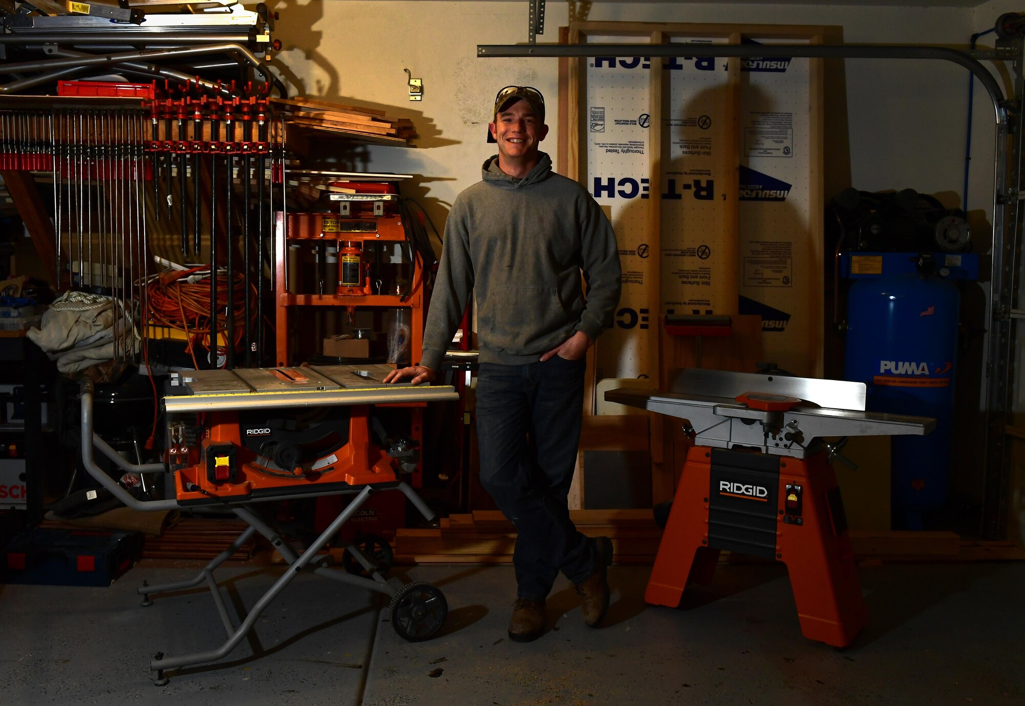 Tech. Sgt. Nicholas, 432nd Maintenance Group Quality Assurance inspector, poses for a photo Dec. 18, 2016, at his home in Las Vegas, Nev. Nicholas shares his woodworking passion by making award plaques and shadow boxes for members of Creech Air Force Base. (U.S. Air Force photo by Senior Airman Christian Clausen/Released)