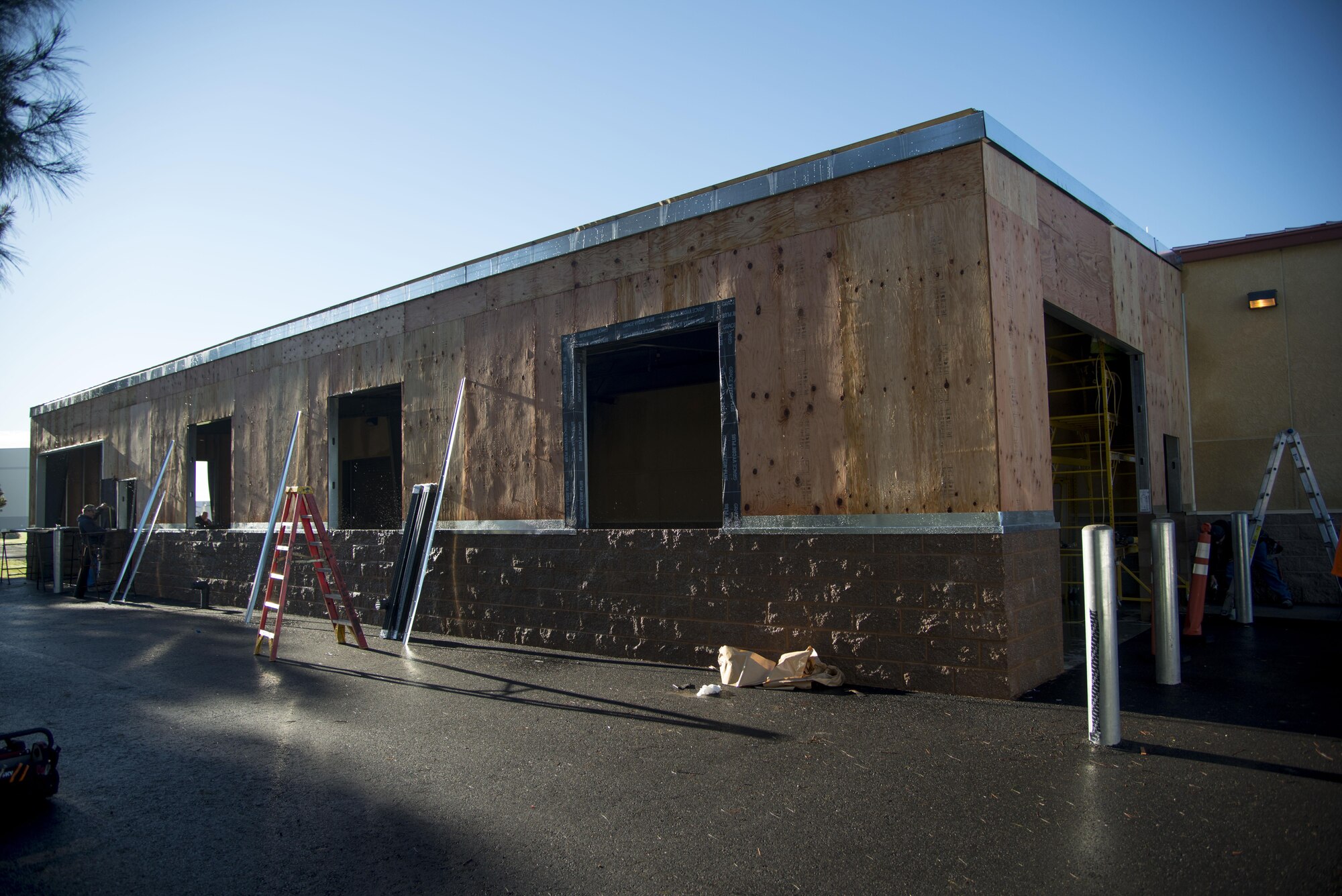 The 60th Maintenance Squadron wheel and tire shop stands with it's new addition being built Jan. 5, 2017 at Travis Air Force Base, Calif. The new addition will provide 2,000 square feet of additional storage for wheels, allowing for a more secure means of storing the wheels, better organization and more room to complete other jobs. (U.S. Air Force photo/Staff Sgt. Nicole Leidholm)