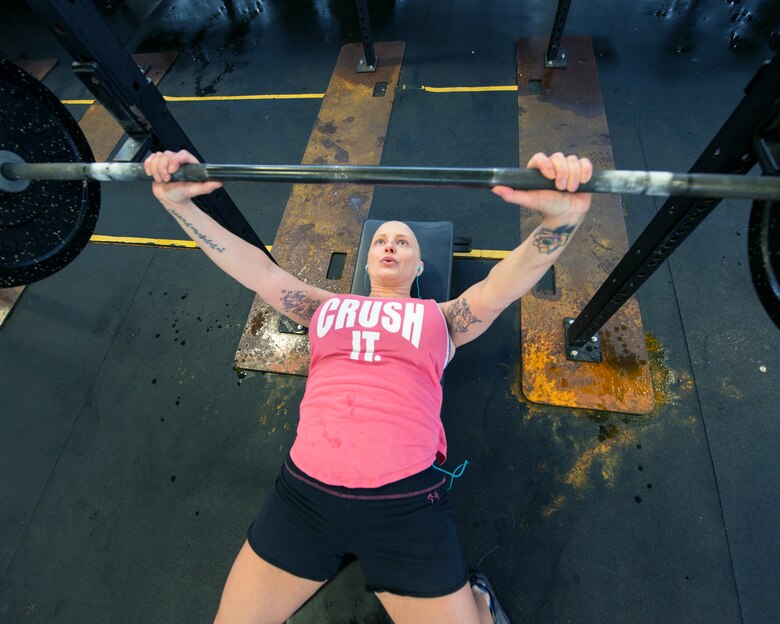U.S. Air Force Master Sgt. Tracey Drake, 60th Medical Operations works out at the Travis Air Force Base, Calif., gymnasium, Jan. 10, 2017. Drake was diagnosed with metastatic breast cancer during her retirement physical in July 2016, 3 weeks before starting terminal leave. Drake faces surgery, radiation, targeted infusion, and reconstruction surgery. (U.S. Air Force photo/Louis Briscese)