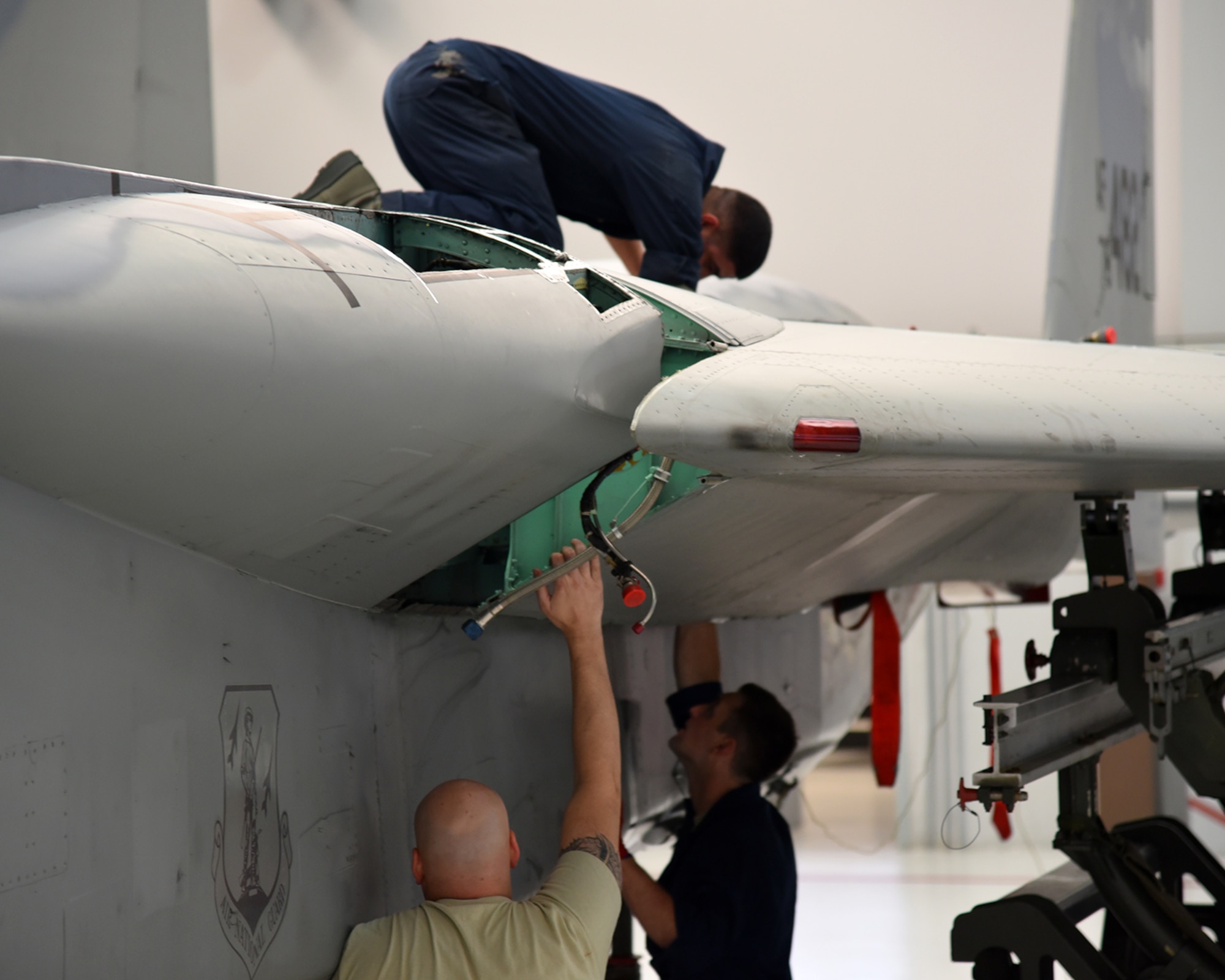 The Depot Field Team from the 402nd Aircraft Maintenance Group, Robins Air Force Base, Ga., attaches a new wing to F-15C Eagle 78-482, assigned to the 142nd Fighter Wing, Portland Air National Guard Base, Ore., Dec. 6, 2016. (U.S. Air National Guard photo by Senior Master Sgt. Shelly Davison, 142nd Fighter Wing Public Affairs)

