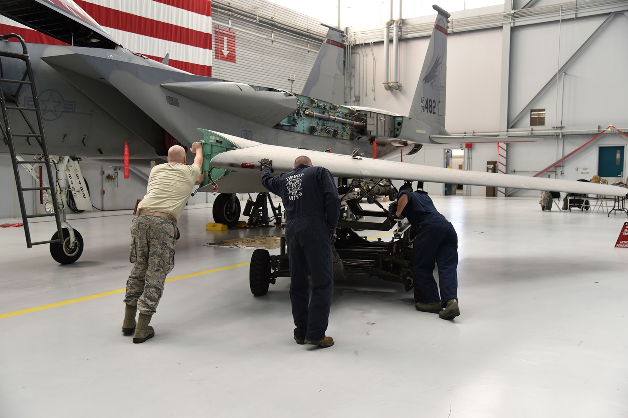 The Depot Field Team from the 402nd Aircraft Maintenance Group, Robins Air Force Base, Ga., move the new wing into place during the wing replacement of F-15C Eagle 78-482, assigned to the 142nd Fighter Wing, Portland Air National Guard Base, Ore., Dec. 6, 2016. (U.S. Air National Guard photo by Senior Master Sgt. Shelly Davison, 142nd Fighter Wing Public Affairs)

