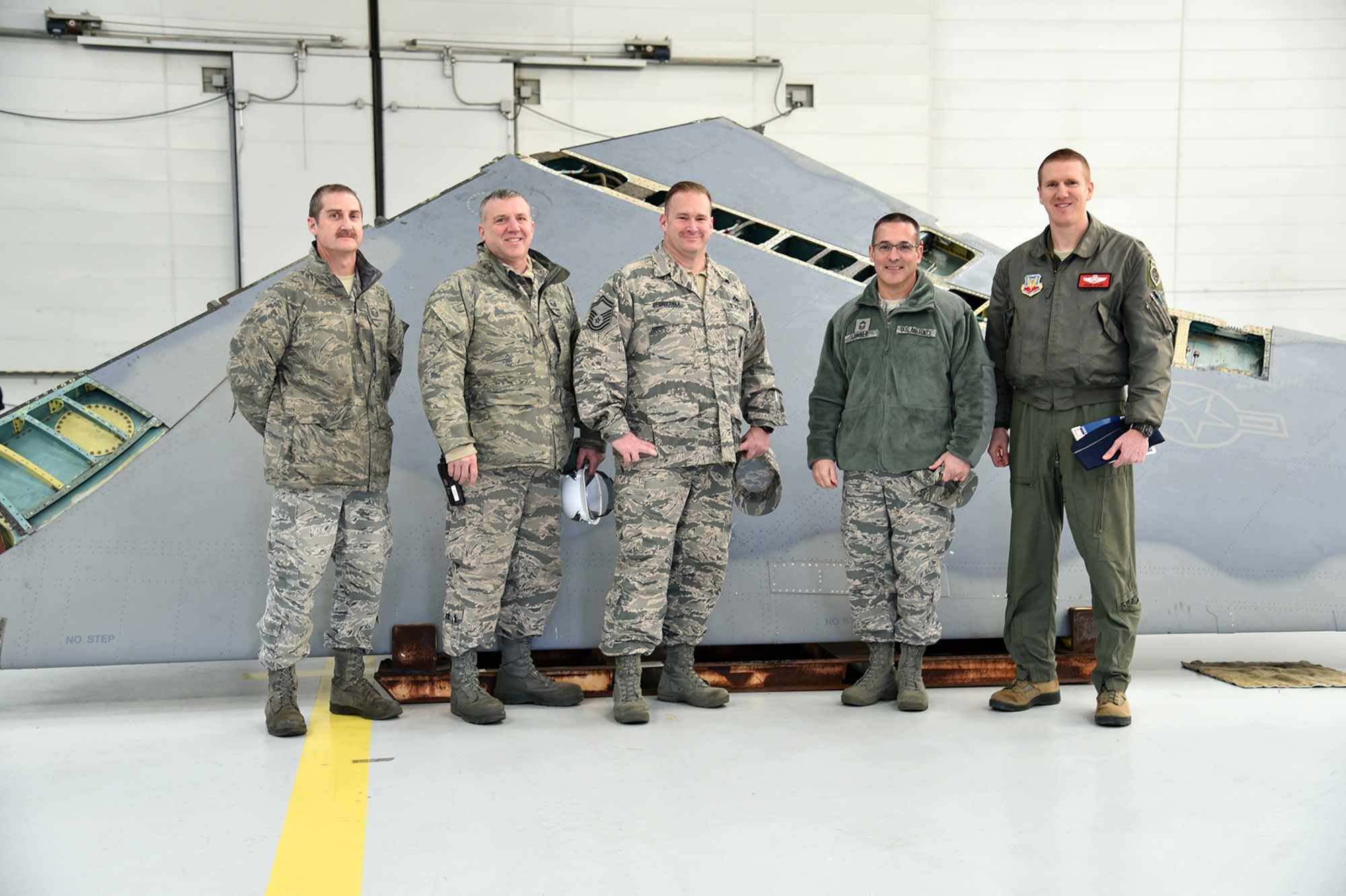 Members of the 142nd Fighter Wing pose for a photo with the removed aircraft wing of F-15C Eagle 78-482, during a wing replacement performed by the Depot Field Team from the 402nd Aircraft Maintenance Group, Robins Air Force Base, Ga., at the Portland Air National Guard Base, Ore., Dec. 6, 2016. (U.S. Air National Guard photo by Senior Master Sgt. Shelly Davison, 142nd Fighter Wing Public Affairs)

