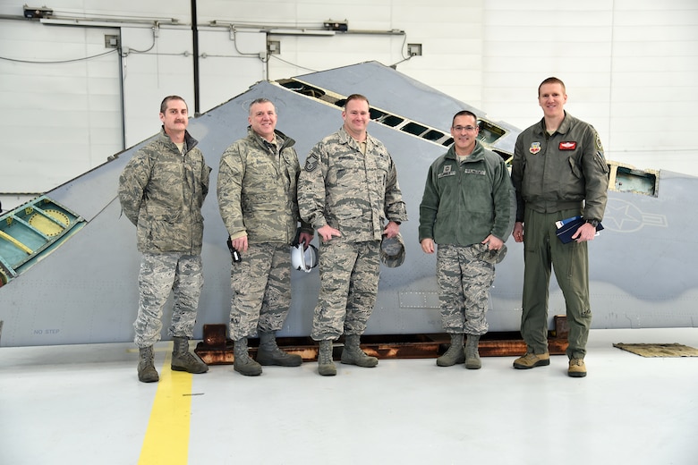 Members of the 142nd Fighter Wing pose for a photo with the removed aircraft wing of F-15C Eagle 78-482, during a wing replacement performed by the Depot Field Team from the 402nd Aircraft Maintenance Group, Robins Air Force Base, Ga., at the Portland Air National Guard Base, Ore., Dec. 6, 2016. (U.S. Air National Guard photo by Senior Master Sgt. Shelly Davison, 142nd Fighter Wing Public Affairs)


