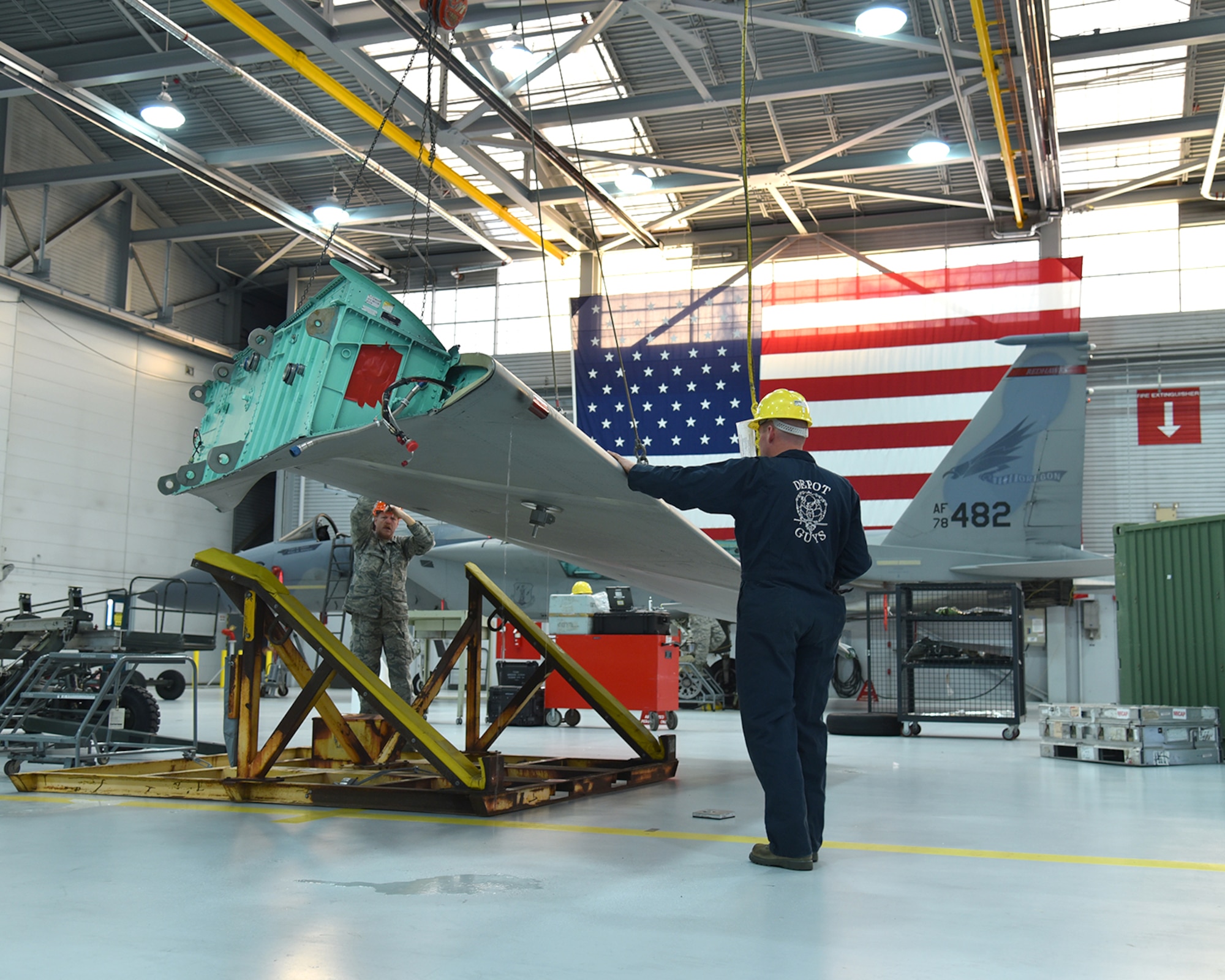 Members of the 142nd Fighter Wing and the Depot Field Team from the 402nd Aircraft Maintenance Group, Robins Air Force Base, Ga., lift a new wing to be placed on an F-15C Eagle assigned to the 142nd Fighter Wing, Portland Air National Guard Base, Ore., Dec. 6, 2016. (U.S. Air National Guard photo by Senior Master Sgt. Shelly Davison, 142nd Fighter Wing Public Affairs)