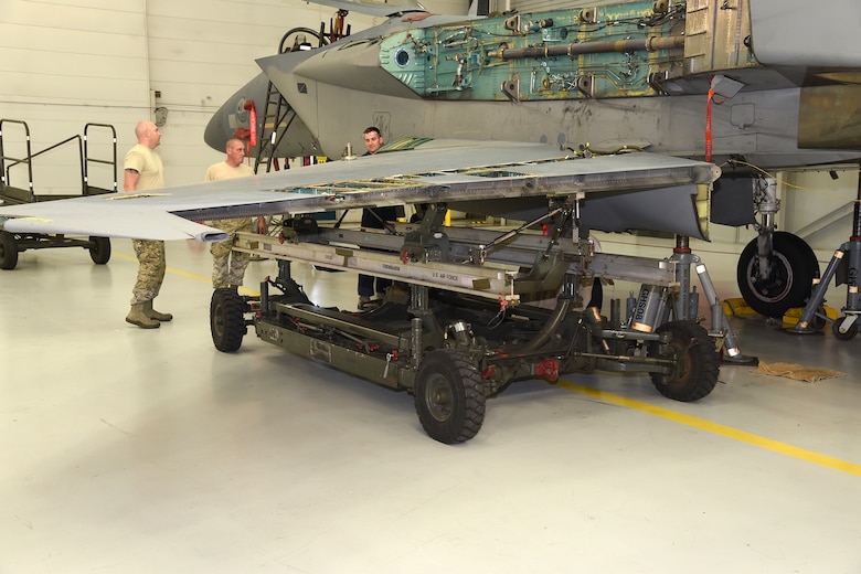 The Depot Field Team from the 402nd Aircraft Maintenance Group, Robins Air Force Base, Ga.,  remove the wing from an F-15C Eagle assigned to the 142nd Fighter Wing, Portland Air National Guard Base, Ore., Dec. 6, 2016. (U.S. Air National Guard photo by Senior Master Sgt. Shelly Davison, 142nd Fighter Wing Public Affairs)