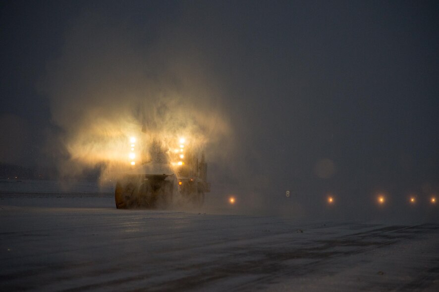 Airmen of 436th Civil Engineer Squadron remove snow from the runway during a snow storm Jan. 7, 2017, at Dover Air Force Base, Del. The Airmen operated vehicles around the clock to ensure the runway was suitable for flight operations. (U.S. Air Force photo by Mauricio Campino)