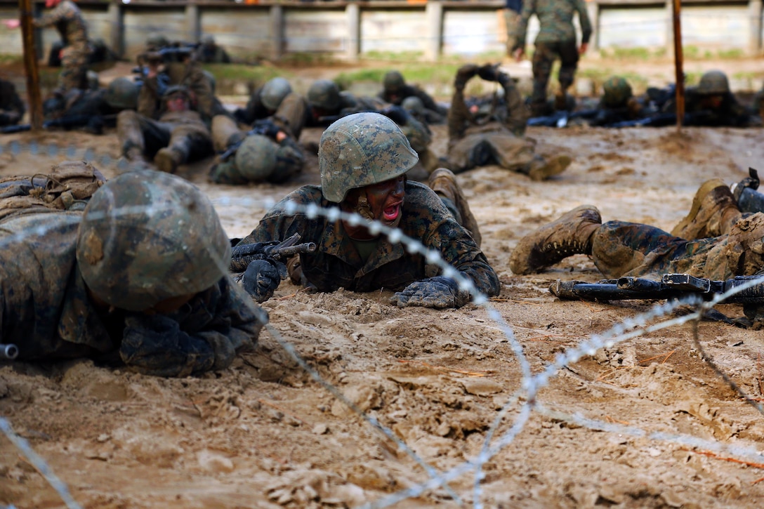 Marine recruits perform low crawls during Basic Warrior Training at Paige Field on Marine Corps Recruit Depot, Parris Island, S.C., Jan. 4, 2017. Basic Warrior Training is a 48 hour training evolution that covers land navigation, improvised explosive devices and fire and movement. Marine Corps photo by Lance Cpl. Sarah Stegall