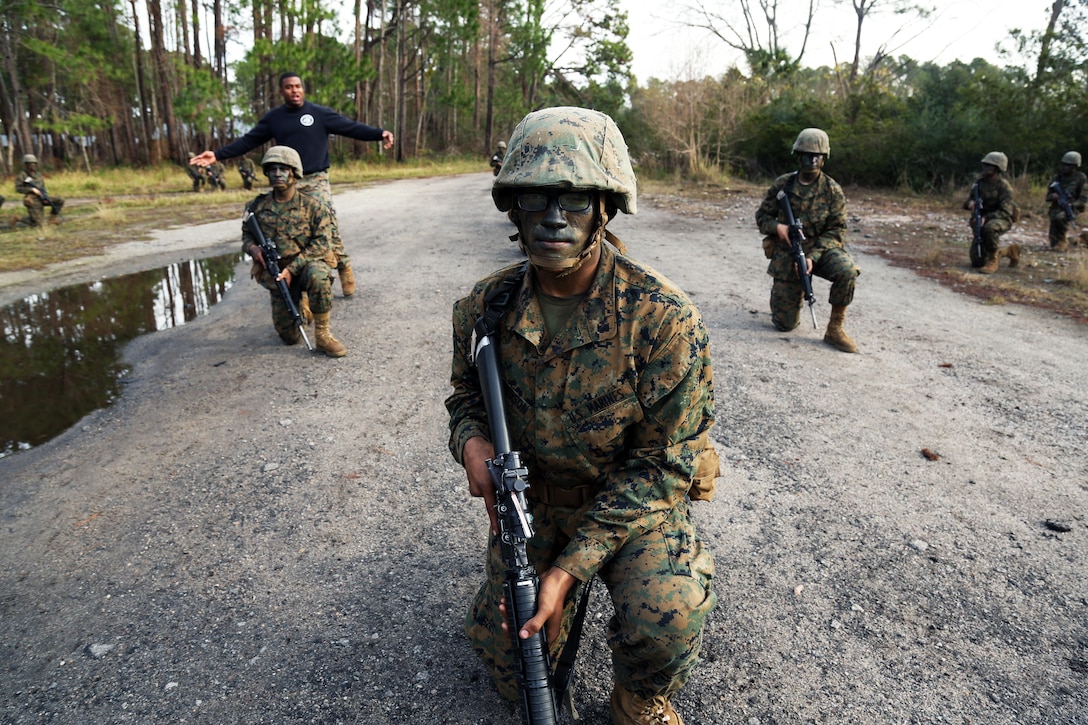 Marine Corps recruit Donovan Davidson practices hand and arm signals during Basic Warrior Training at Paige Field on Marine Corps Recruit Depot, Parris Island, S.C., Jan. 4, 2017. Basic Warrior Training is a 48 hour training evolution that covers land navigation, improvised explosive devices and fire and movement. Marine Corps photo by Lance Cpl. Sarah Stegall