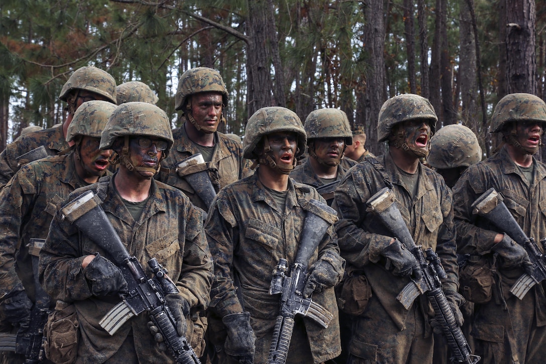 Marine Corps recruits stand in formation at the beginning of Basic Warrior Training at Paige Field on Marine Corps Recruit Depot, Parris Island, S.C., Jan. 4, 2017. Basic Warrior Training is a 48 hour training evolution that covers land navigation, improvised explosive devices and fire and movement. The recruits are assigned to Platoon 1004, Company C, 1st Battalion, Recruit Training Regiment. Marine Corps photo by Lance Cpl. Sarah Stegall