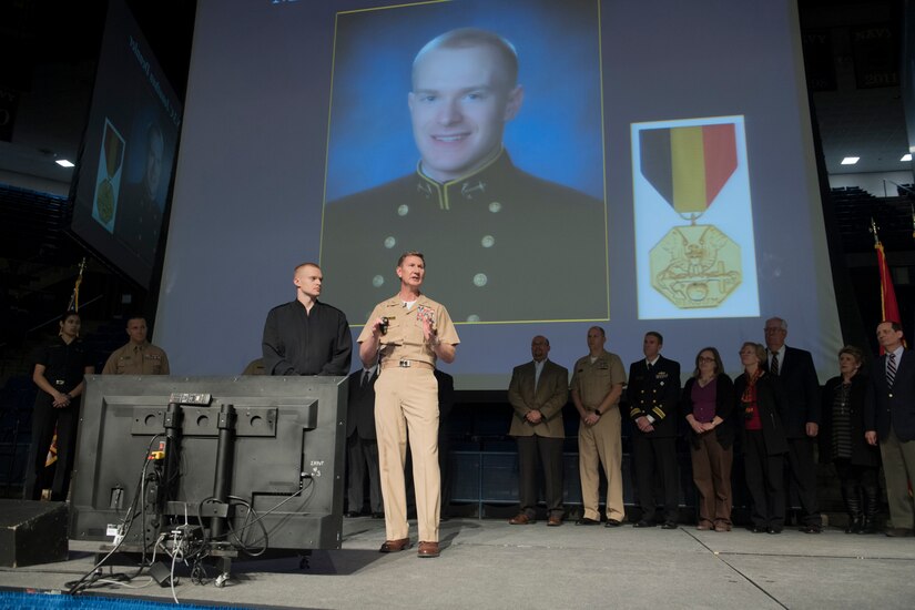 Navy Vice Adm. Ted Carter, the superintendent of the U.S. Naval Academy, right, speaks to the Brigade of Midshipman about the Navy and Marine Corps Medal awarded to Midshipman 3rd Class Jonathan Dennler during a ceremony at Alumni Hall in Annapolis, Md., Jan. 9, 2017. Navy photo by Kenneth Aston