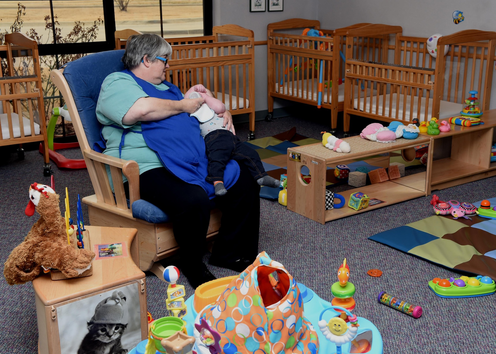 Donna Shackelford, 97th Force support Squadron Child Development Program Assistant, feeds an infant at the Child Development Center, January 4, 2017. The CDC provides a safe and healthy learning environment so that Department of Defense civilian and military personnel can focus on the mission knowing their children are well taken care of during the duty day.