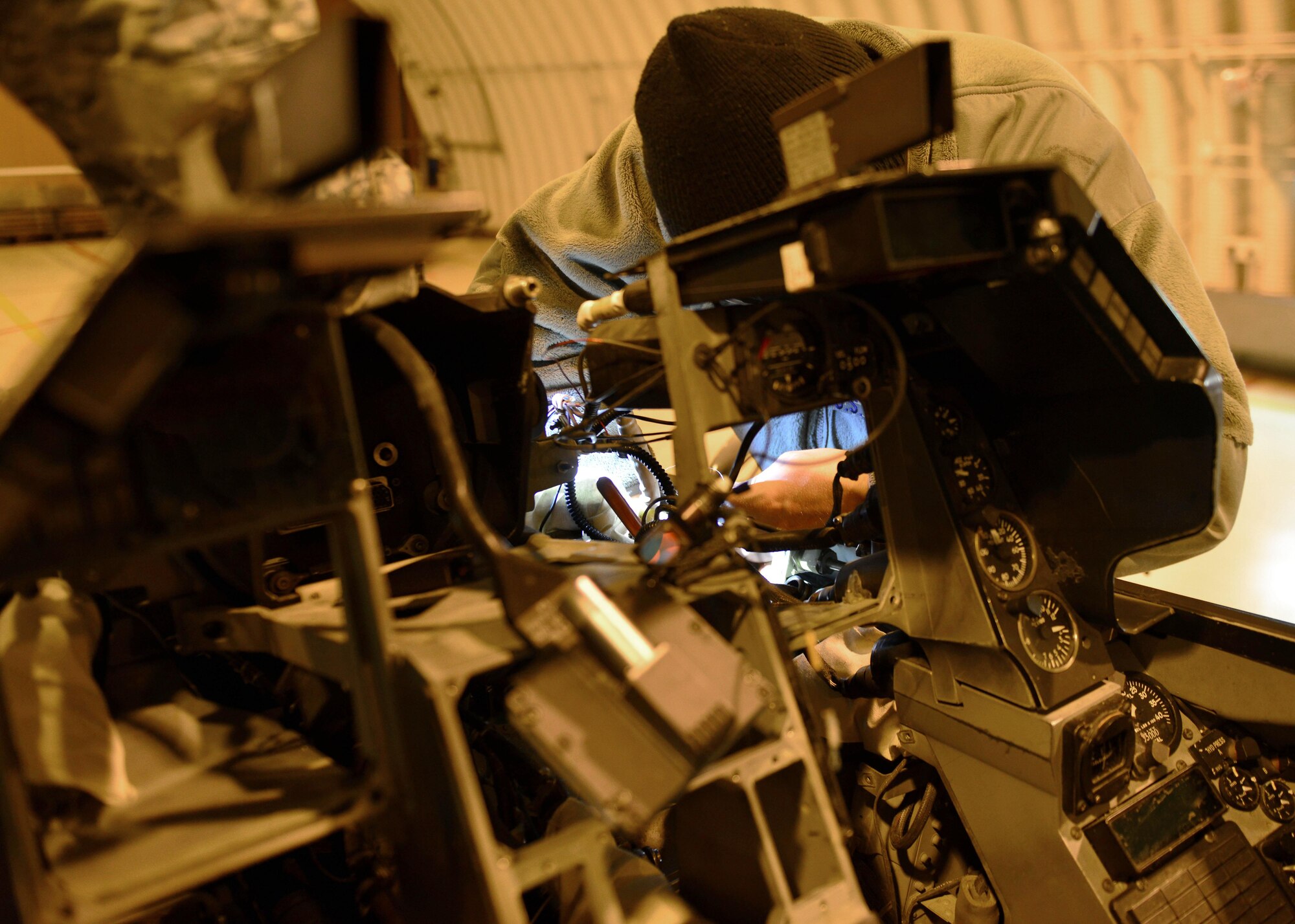 Senior Airman Glen Ratliff, 31st Maintenance Squadron Aircrew Egress Systems journeyman, installs a detonating transfer assembly line in an F-16 Fighting Falcon at Aviano Air Base, Italy recently. The assembly line was installed as part of the ejection seat and canopy deployment system.  (U.S. Air Force photo by Senior Airman Cary Smith)