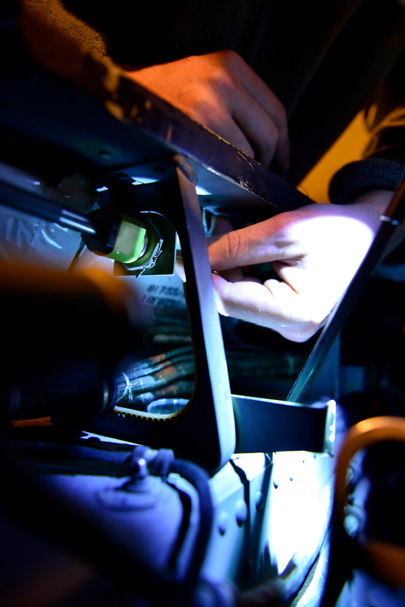 Senior Airman Glen Ratliff, 31st Maintenance Squadron egress systems journeyman, installs a detonating transfer assembly line in an F-16 Fighting Falcon at Aviano Air Base, Italy recently. The Aircrew Egress Systems flight monitors the expiration and functionality of more than 60 parts that make up the ejection system. (U.S. Air Force photo by Senior Airman Cary Smith)