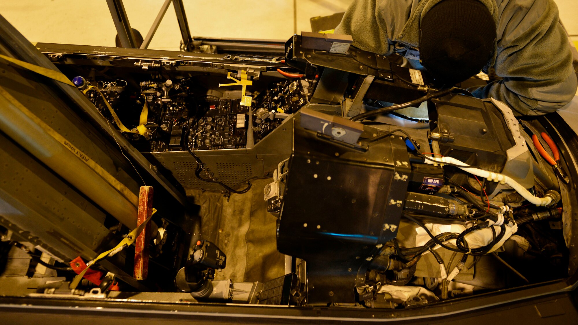 Senior Airman Glen Ratliff, 31st Maintenance Squadron Aircrew Egress Systems journeyman, installs a detonating transfer assembly line in an F-16 Fighting Falcon at Aviano Air Base, Italy recently. The assembly line transfers an electrical signal to the ejection seat should a pilot need to pull the ejection lever in an emergency. (U.S. Air Force photo by Senior Airman Cary Smith)