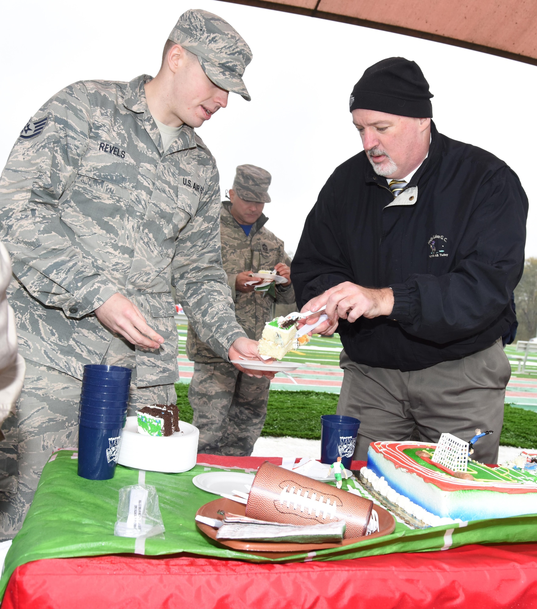 David Curley, 78th Force Support Squadron director, serves cake during the 78th Force Support Squadron Track & Field Dedication. The new track will improve safety, save money and provide year-round activity for Team Robins. (U.S. Air Force photo by Ed Aspera)