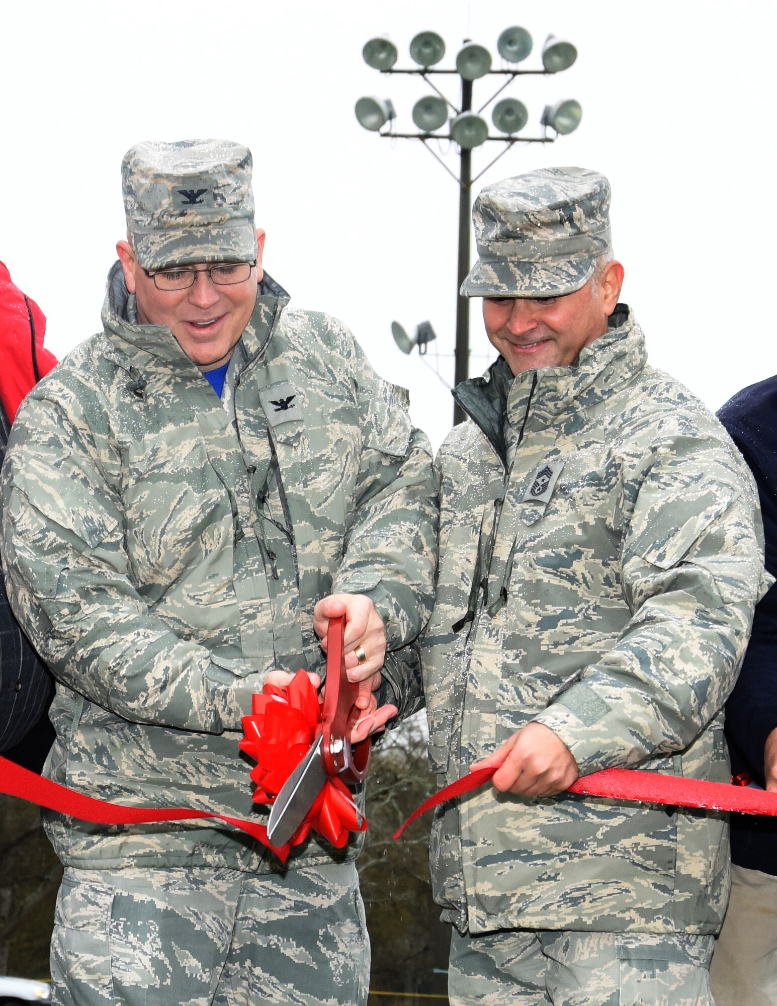 Col. Jeff King, 78th Air Base Wing commander, and Chief Master Sgt. Emilio Hernandez, 78th AFB command chief, take part in the ribbon cutting during the 78th Force Support Squadron Track & Field Dedication. (U.S. Air Force photo by Ed Aspera)