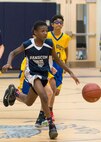 Hanscom Middle School's Derion Felton drives past defenders during the team's first home game at HMS Jan. 10. The HMS Falcons beat Acton-Boxborough R.J. Grey Junior High School in overtime 38 to 34. (U.S. Air Force photo by Mark Herlihy)
