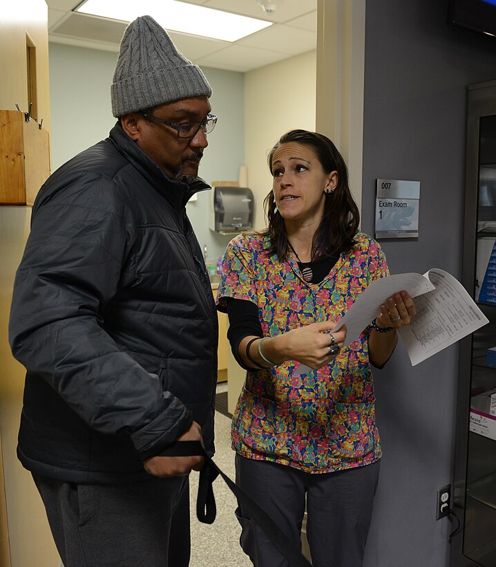 Retired U.S. Navy Chief Hospital Corpsman James Holden, speaks with Jo Marie Edmister, Langley Veterinarian Clinic animal health care assistant, regarding heartworm, flea and tick prevention medication at Joint Base Langley-Eustis, Va., Jan. 5, 2017. The veterinary clinics provide price comparison lists for clinic medications alongside major distribution website prices, and make recommendations based on the animal’s needs. (U.S. Air Force photo by Staff Sgt. Teresa J. Cleveland)