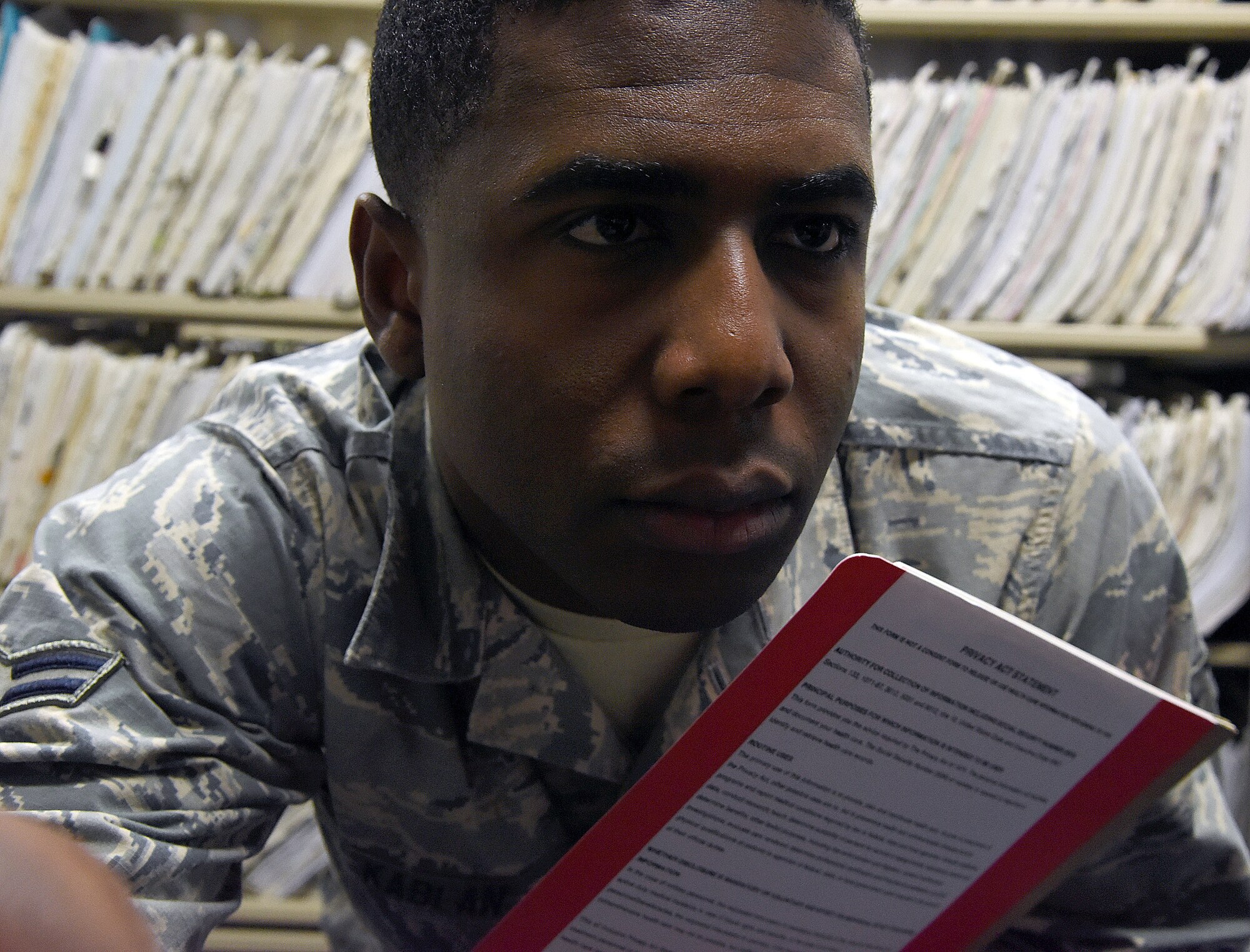 Airman 1st Class Tayorau Kablan, 341st Medical Support Squadron outpatient records technician, looks through medical records at the base clinic Jan. 9, 2016, at Malmstrom Air Force Base, Mont. Kablan is originally from the Ivory Coast, West Africa, and has been stationed at Malmstrom for four months. (U.S. Air Force photo/Senior Airman Jaeda Tookes)