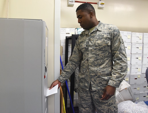 Airman 1st Class Tayorau Kablan, 341st Medical Support Squadron outpatient records technician, shreds papers at the base clinic Jan. 9, 2016, at Malmstrom Air Force Base, Mont. Kablan is oringally from the Ivory Coast, West Africa, and chose to serve in the military in the footsteps of his grandfather, who was a World War II French Army veteran. (U.S. Air Force photo/Senior Airman Jaeda Tookes)