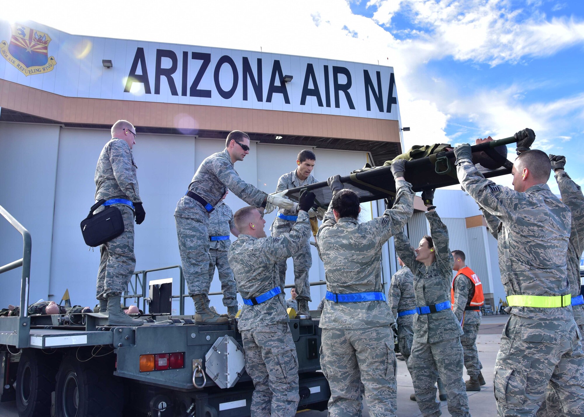 Airmen from the 944th Aeromedical Staging Squadron work together to load a simulated patient onto a K-loader Jan. 7 during a joint patient movement training exercise at Goldwater Air National Guard Base, Ariz. (U.S. Air Force photo by Tech. Sgt. Louis Vega Jr.)