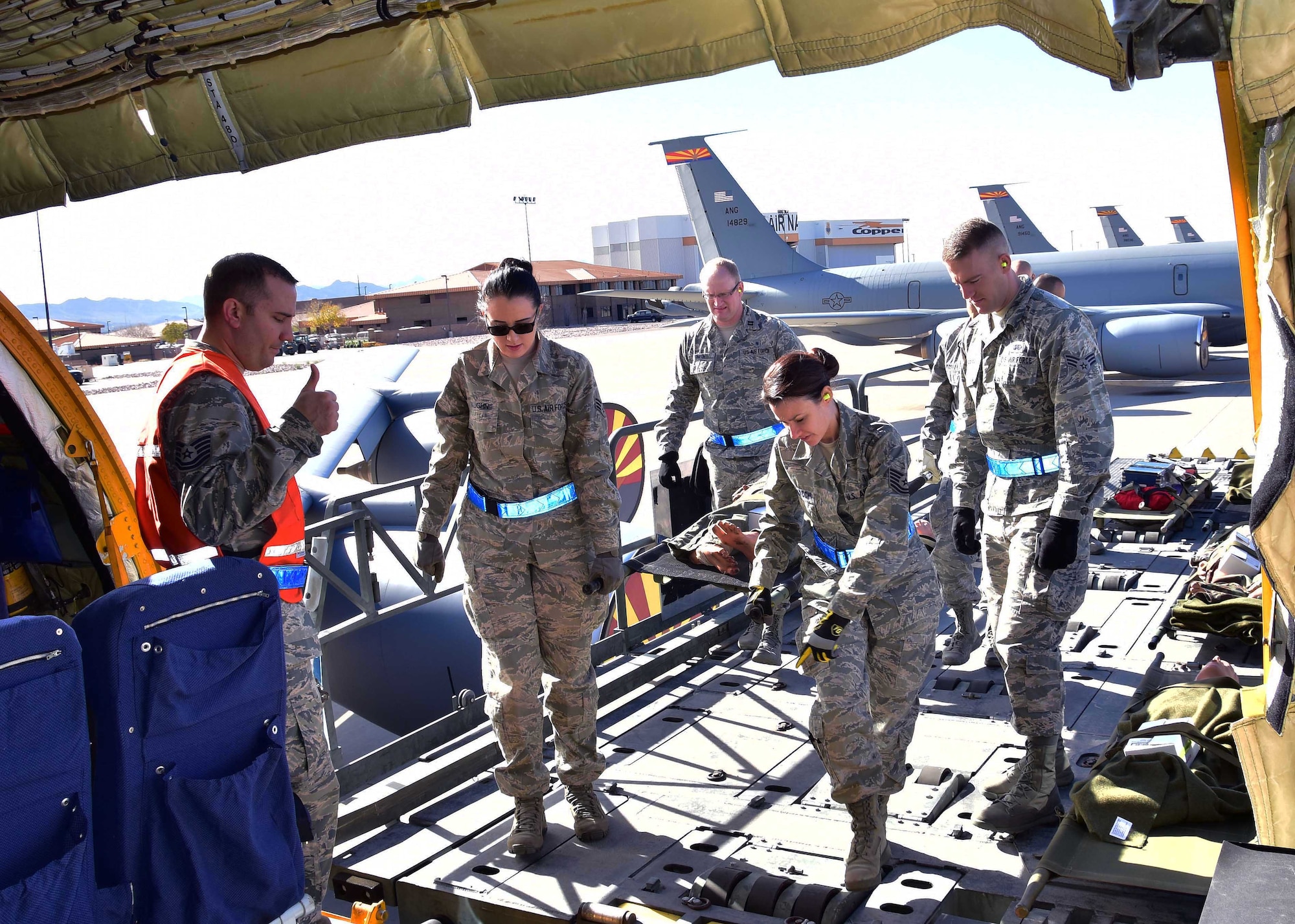 Airmen from the 944th Aeromedical Staging Squadron transport a simulated patient from a K-loader to a KC-135 Jan. 7 during a joint patient movement training exercise at Goldwater Air National Guard Base, Ariz. (U.S. Air Force photo by Tech. Sgt. Louis Vega Jr.)