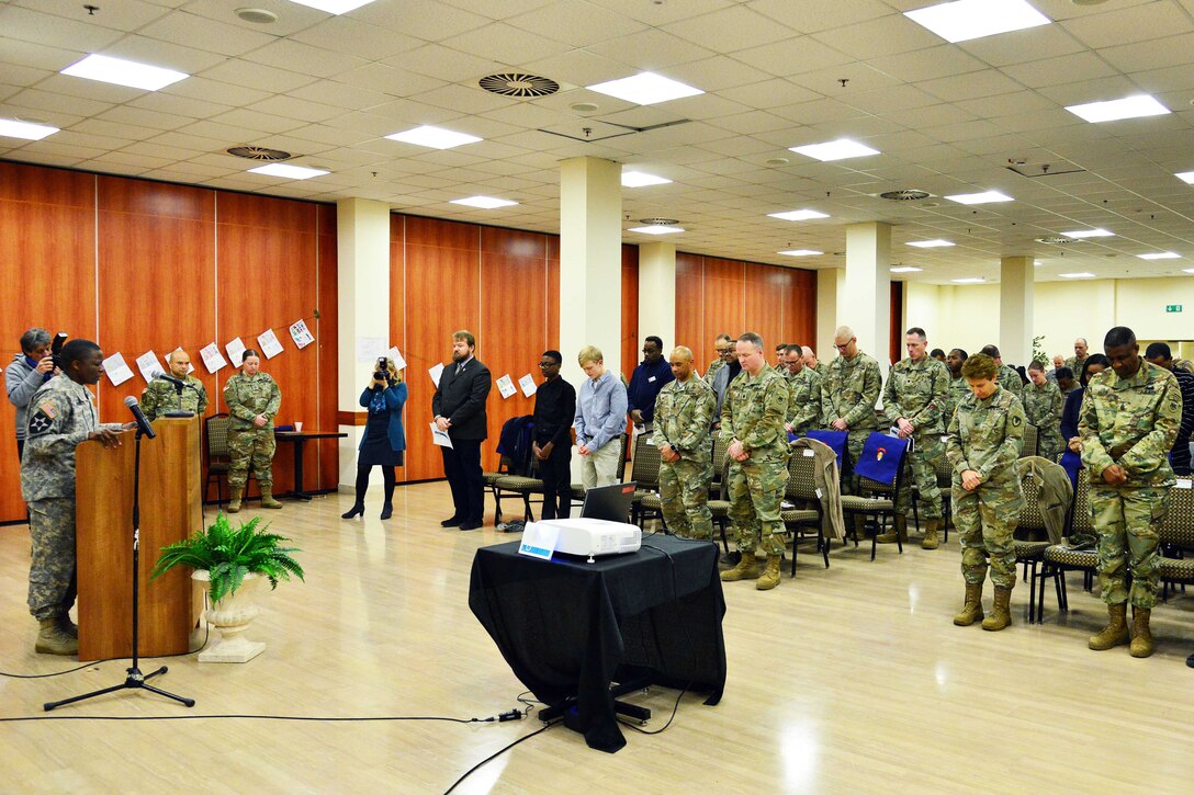 Army Master Sgt. T. D. (Terri) Gordon, far left, offers a prayer during the Dr. Martin Luther King Jr. Day observance at Caserma Ederle, Vicenza, Italy, Jan. 10, 2017. Army photo by Paolo Bovo