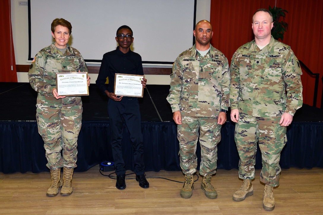 From left to right: Army Col. Christine A. Beeler, commander of the 414th Contracting Support Brigade; Anthony Malik Thompson of Vicenza High School; Command Sgt. Maj. Birdel L. Campbell, U.S. Army Africa; and Lt. Col. Brett M. Medlin, battalion commander of U.S. Army Africa; pose for a photo during the Dr. Martin Luther King Jr. observance at Caserma Ederle, Vicenza, Italy, Jan. 10, 2017. Army photo by Paolo Bovo