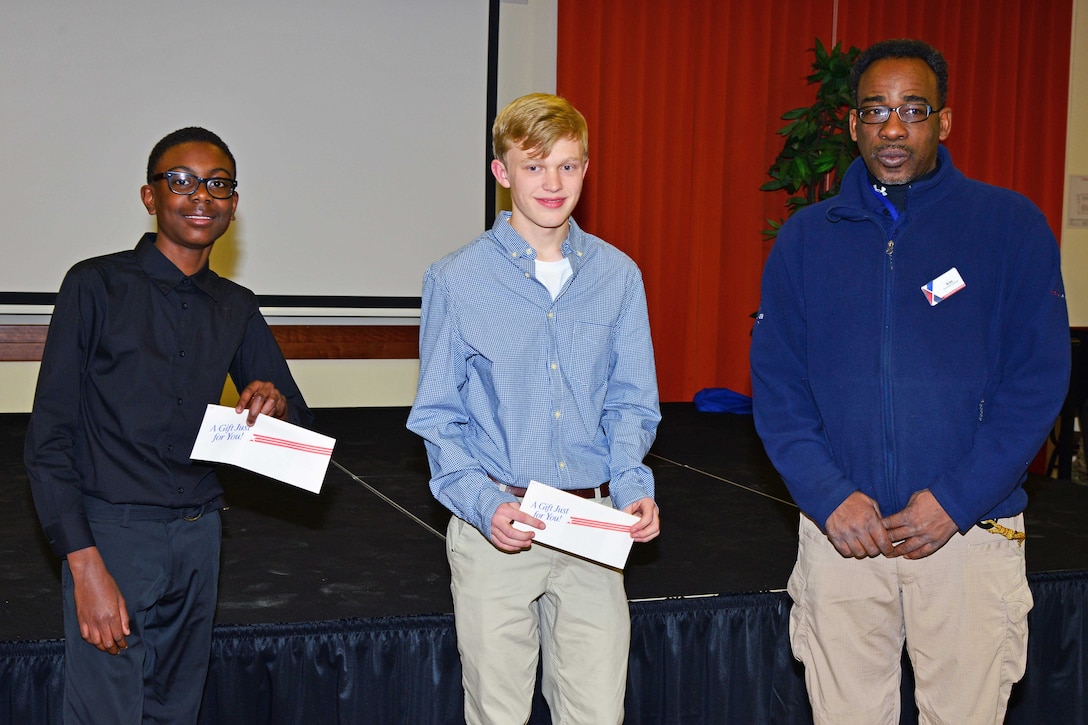 From left to right: Anthony Malik Thompson, Alex Wepper of Vicenza High School and Kim Burton, assistant manager of the Vicenza Army/Air Force Exchange Service, pose for a photo at the Dr. Martin Luther King Jr. observance at Caserma Ederle, Vicenza, Italy, Jan. 10, 2017. Army photo by Paolo Bovo