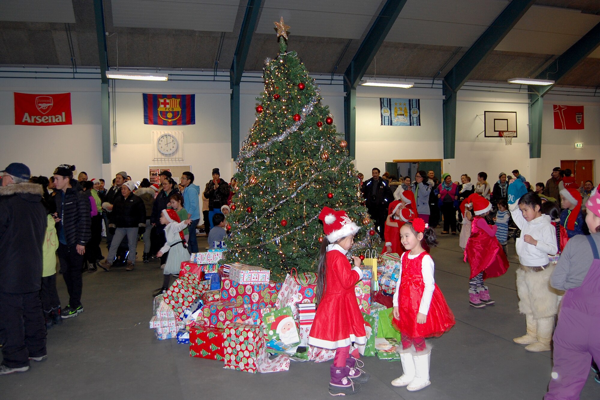 QAANAAQ, Greenland – Children play around a holiday tree during Operation Julemond in the local community of Qaaanaaq, Greenland, Dec. 22, 2016. Every year during Operation Julemond, gifts are sent to the Greenlandic villages of Qaanaaq, Qeqertat, Savisivik and Siorapaluk for the children who live at the top of the world. (U.S. Air Force photo by Tech. Sgt. Shawn Joseph)