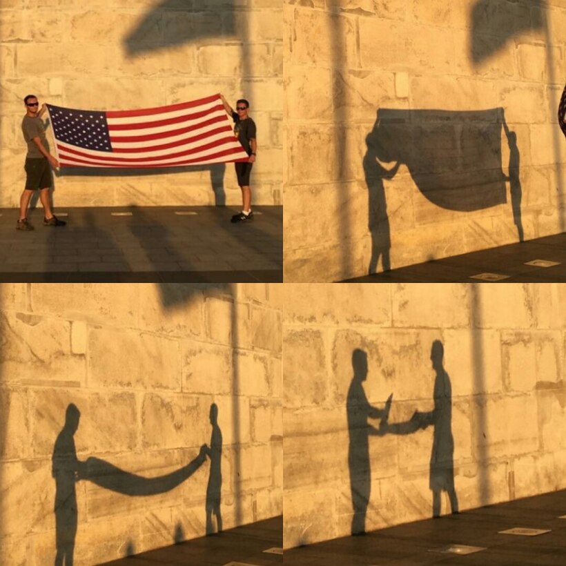 Staff Sgt. Jonathan Balko, an electrical and environmental craftsman assigned to the 28th Aircraft Maintenance Squadron, left, folds his American flag in front of the Washington Monument in Washington, D.C. From a young age, Balko knew he wanted to have a career related to military aviation. (Courtesy photo)