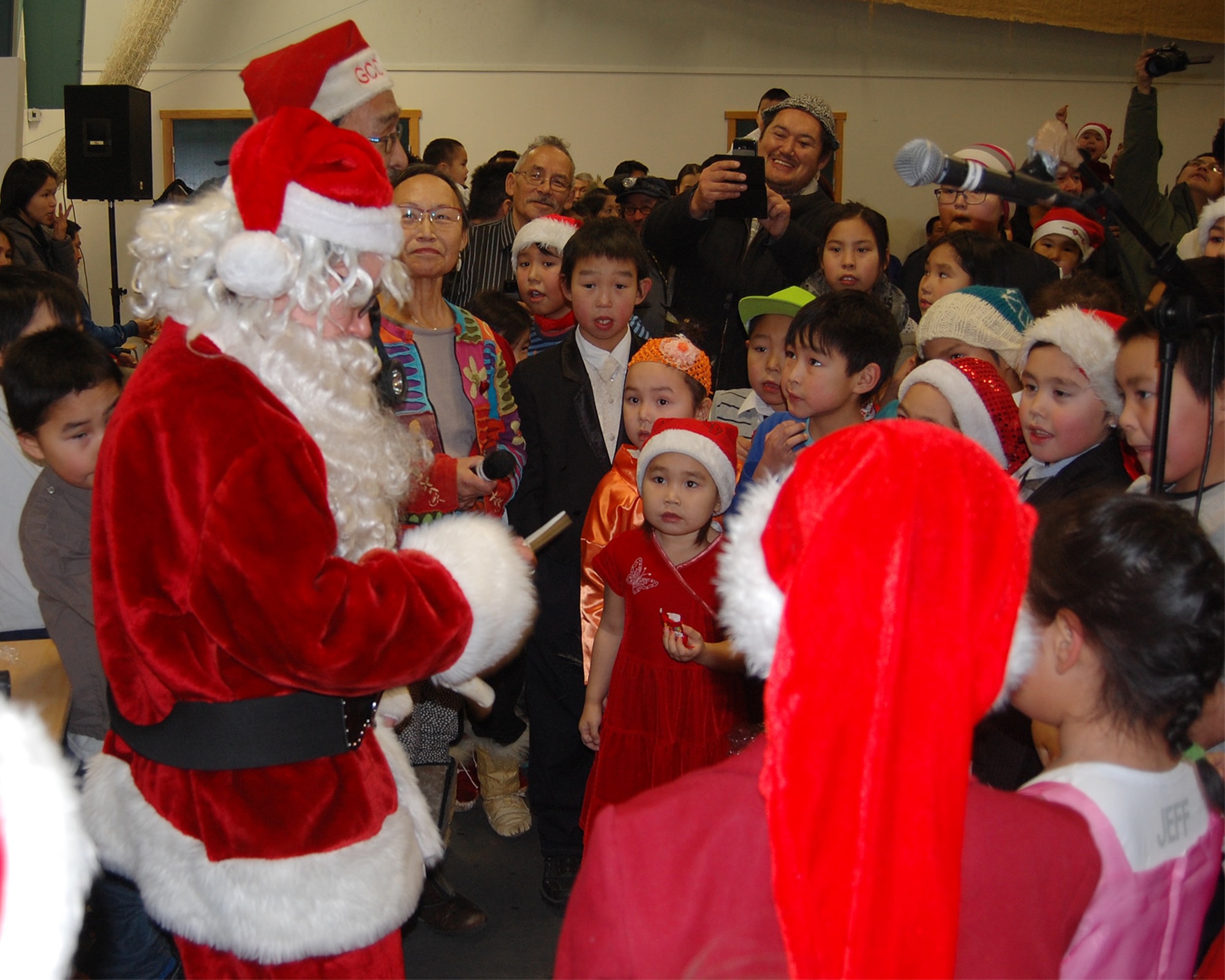 QAANAAQ, Greenland – Santa Claus and 821st Air Base Group leadership at Thule Air Base, Greenland, talk with local children and hand out goodies during Operation Julemond in the local community of Qaanaq, Dec. 22, 2016. Village families gather every year to celebrate the international relationship with songs around the Christmas tree, hugs, laughter and gifts. (U.S. Air Force photo by Tech. Sgt. Shawn Joseph)