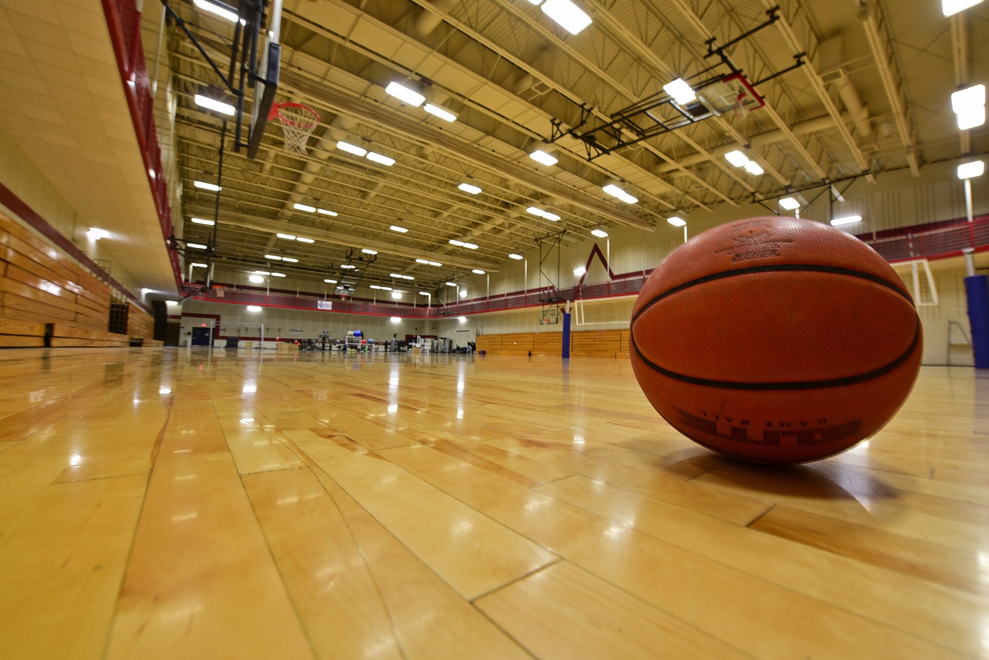 A basketball sits ready to be dribbled on one of the full sized basketball courts in the Bellamy Fitness Center at Ellsworth Air Force Base, S.D., Jan. 9, 2017. The fitness center boasts a variety of rooms with exercise equipment ranging from free weights, cardio machines and an indoor swimming pool. (U.S. Air Force photo by Airman 1st Class James L. Miller)
