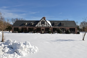 Snow surrounds the 633rd Air Base Wing Headquarters building after winter storm Helena at Joint Base Langley-Eustis, Va., Jan. 10, 2017. The winter storm affected a large part of the United States starting Jan. 4 and ending Jan. 8. (U.S. Air Force photo by Airman 1st Class Tristan Biese)