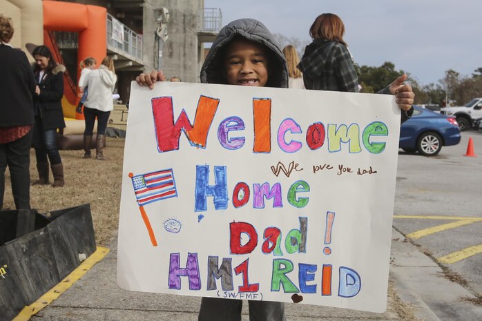 Son of PO1 Scott Reid shows off the sign him and his brother made for the return of their father at Camp Lejeune, N.C., Jan. 10, 2017. Reid was on a nine-month deployment with Special Purpose Marine Air-Ground Task Force Crisis Response-Africa; a rotation in place to protect U.S. personnel, property and interests in Europe and Africa. Reid is a Corpsman with 2nd Marine Logistics Group. (U.S. Marine Corps photo by Lance Cpl. Miranda Faughn)