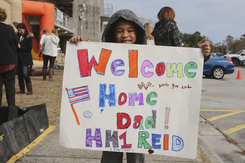 Son of PO1 Scott Reid shows off the sign him and his brother made for the return of their father at Camp Lejeune, N.C., Jan. 10, 2017. Reid was on a nine-month deployment with Special Purpose Marine Air-Ground Task Force Crisis Response-Africa; a rotation in place to protect U.S. personnel, property and interests in Europe and Africa. Reid is a Corpsman with 2nd Marine Logistics Group. (U.S. Marine Corps photo by Lance Cpl. Miranda Faughn)