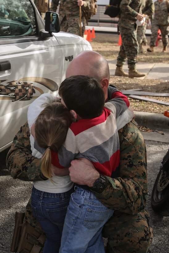 A Marine surprises his two children following a nine-month deployment with Special Purpose Marine Air-Ground Task Force Crisis Response-Africa at Camp Lejeune, N.C., Jan. 10, 2017. Marines and sailors with SPMAGTF-CR-AF return home after completing the mission of protecting U.S. personnel, property and interests in Europe and Africa. The Marines and sailors returning are with Combat Logistics Battalion 2. (U.S. Marine Corps photo by Lance Cpl. Miranda Faughn)