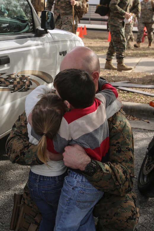 A Marine surprises his two children following a nine-month deployment with Special Purpose Marine Air-Ground Task Force Crisis Response-Africa at Camp Lejeune, N.C., Jan. 10, 2017. Marines and sailors with SPMAGTF-CR-AF return home after completing the mission of protecting U.S. personnel, property and interests in Europe and Africa. The Marines and sailors returning are with Combat Logistics Battalion 2. (U.S. Marine Corps photo by Lance Cpl. Miranda Faughn)