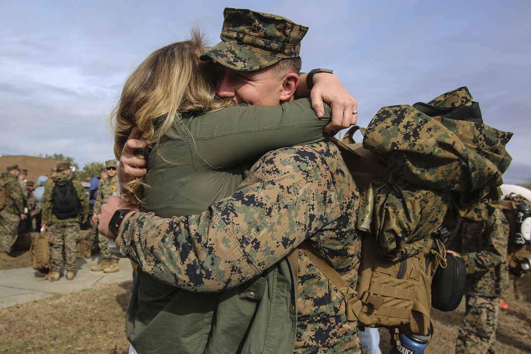 A Marine embraces a loved one during Special Purpose Marine Air-Ground Task Force Crisis Response-Africa’s homecoming at Camp Lejeune, N.C., Jan. 10, 2017. After completing the mission of protecting U.S. personnel, property and interests in Europe and Africa, Marines returned home safely from their nine-month deployment. The Marines and sailors returning are with Combat Logistic Battalion 2 (U.S. Marine Corps photo by Lance Cpl. Miranda Faughn)