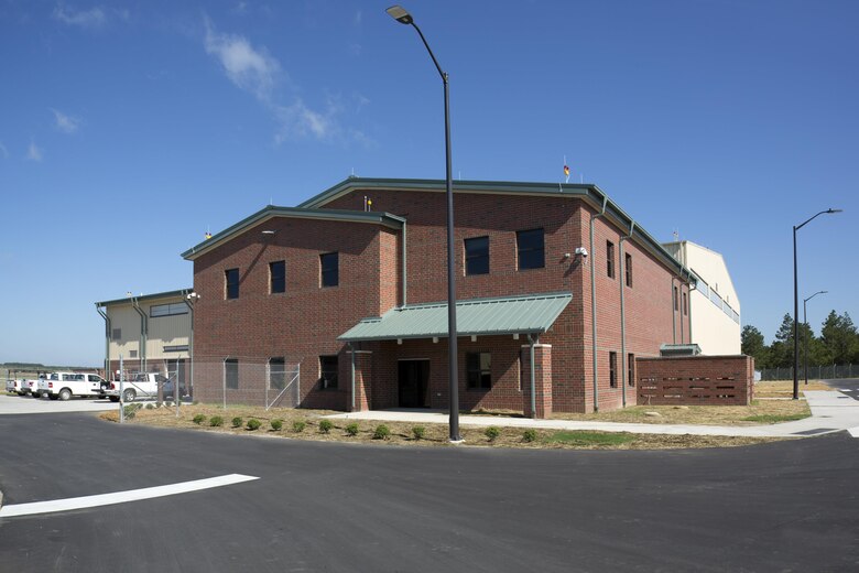 A photo of the Unmanned Aerial Systems hangar constructed at Camp Mackall near Fort Bragg, North Carolina. The facility, built by Caddell Construction, won the state and national-level Associated Builders and Constractors, Inc. Excellence in Construction Competition in December 2016. It also received state-level honors from the Associated General Contractors of America. It will be home to the UAS MQ-1C Gray Eagle and feature operations and maintenance hangar with shops and supply, company administration and supply space, tool and parts storage, 5-ton bridge crane, oil water separator, oil and hazardous material storage, aircraft container storage, organizational vehicle parking, information systems, fire protection and alarm systems, intrusion detection installation and Energy Monitoring Control Systems (EMCS) connection. Work also included runway overlay, replace taxiway and shoulders, taxiway lighting, and access apron.