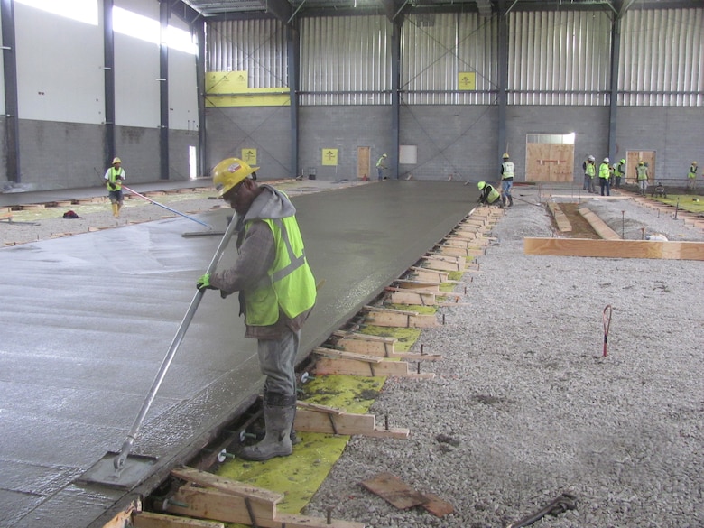 Workers on the newly unveiled Unmanned Aerial Systems hangar constructed at Camp Mackall near Fort Bragg, North Carolina. The facility, built by Caddell Construction, won the state and national-level Associated Builders and Constractors, Inc. Excellence in Construction Competition in December 2016. It also received state-level honors from the Associated General Contractors of America.