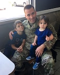 Texas Army National Guard Staff Sgt. Dias, recruiting and retention officer for the Recruiting and Retention Battalion, enjoys lunch with his six-year-old son Gavin, left, and 18-month-old Aeryn, right, at a resturant Nov. 12, 2016, in Tyler, Texas. Dias is responsible for rendering aid and saving the life a blind pedestrian who was struck by a vehicle in East Texas. 