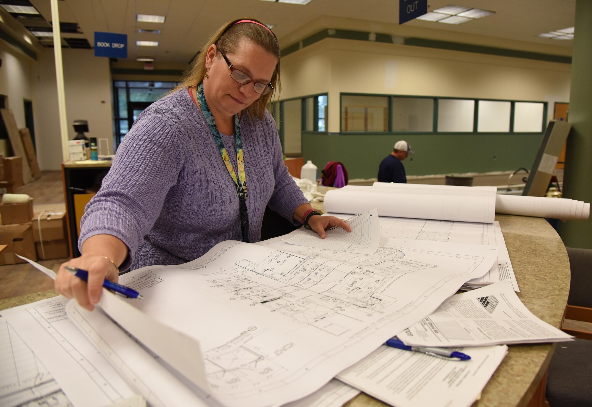 Michelle Bain, Base Operations facility space manager, reviews construction documents at the McBride Commons Jan. 6, 2017, on Keesler Air Force Base, Miss. The McBride Commons renovation project will transition the former base library into a common area which will include a children’s library, computer stations, engraving, framing, marketing and print shops and a full kitchen. The nine-month project is expected to be complete by May 2017. (U.S. Air Force photo by Kemberly Groue) 