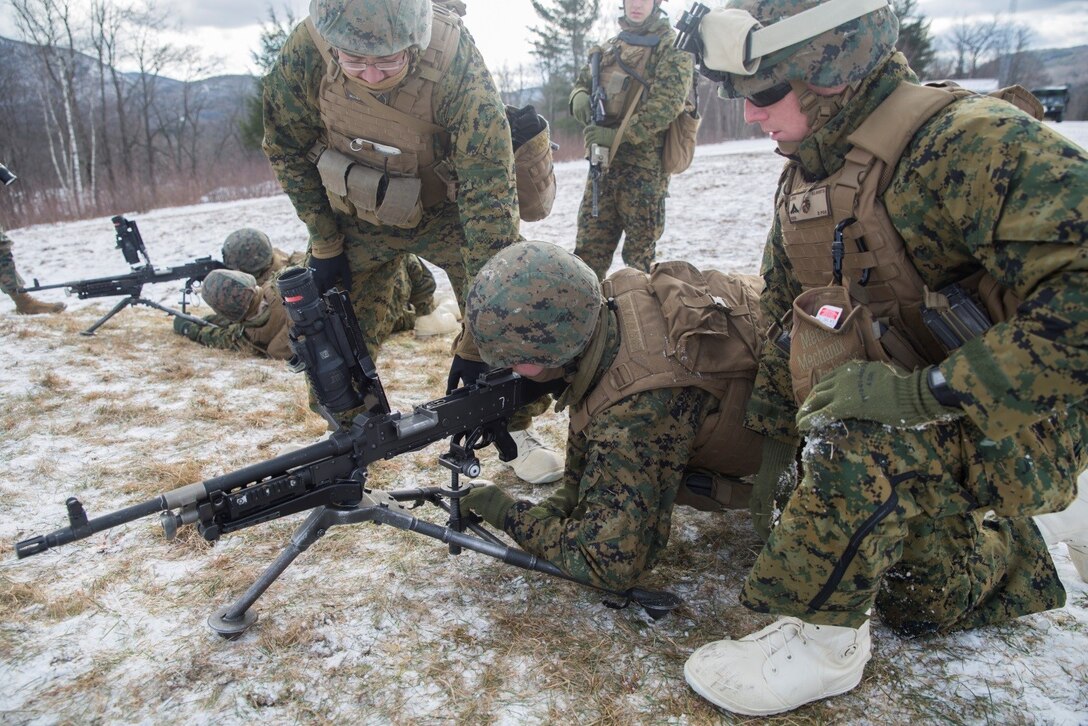 Marines with Company K, 3rd Battalion, 25th Marine Regiment, 4th Marine Division, simulate clearing out machine guns during exercise Nordic Frost at Camp Ethan Allen Training Site in Jericho, Vt., Jan. 6. 2017. The training ensures Marines understand how to properly and safely handle the weapon before receiving live ammunition. (U.S. Marine Corps photo by Cpl. Melissa Martens/ Released)  
 
