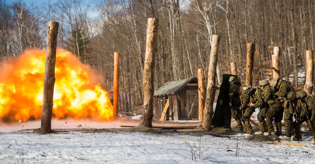 Marines with Weapons Company, 3rd Battalion, 25th Marine Regiment, 4th Marine Division, take cover as a fence charge is detonated during exercise Nordic Frost at Camp Ethan Allen Training Site in Jericho, Vt., Jan. 7. 2017. The Marines were evaluated on their ability to successfully operate demolitions in a demanding cold-weather environment. (U.S. Marine Corps photo by Cpl. Melissa Martens/ Released)