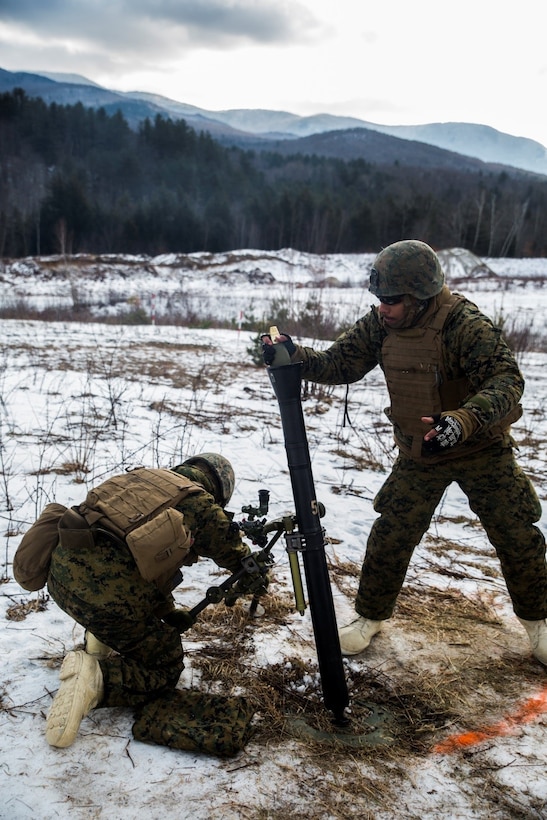 Pfc. Connor R. Leahy (left), and Lance Cpl. Nicholas T. Sams, mortar Marine, for Weapons Company, 3rd Battalion, 25th Marine Regiment, 4th Marine Division, load and fire 81mm mortar rounds during exercise Nordic Frost at Camp Ethan Allen Training Site in Jericho, Vt., Jan. 7. 2017. Throughout the exercise, Marines conduct training in a demanding cold- weather environment that places an emphasis on small-unit leadership. (U.S. Marine Corps photo by Cpl. Melissa Martens/ Released)