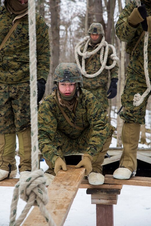 Lance Cpl. Jay Westbrook, assaultman, Company K, 3rd Battalion, 25th Marine Regiment, 4th Marine Division, constructs a wooden bridge while participating in the Leadership Reaction Course during exercise Nordic Frost at Camp Ethan Allen Training Site in Jericho, Vt., Jan. 8. 2017. The LRC is designed to use small-unit leadership to overcome obstacles, which is one of the main focuses of exercise Nordic Frost. (U.S. Marine Corps photo by Cpl. Melissa Martens/ Released) 