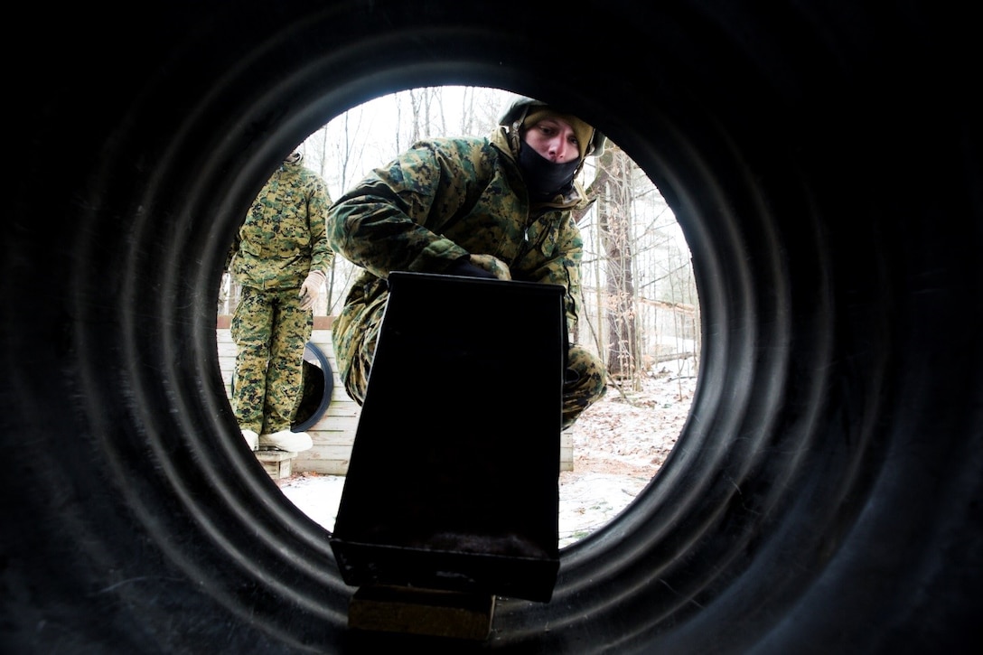 Lance Cpl. Joshua Ruzbacki, rifleman, Company K, 3rd Battalion, 25th Marine Regiment, 4th Marine Division, navigates an ammo can though a tunnel while participating in the Leadership Reaction Course during exercise Nordic Frost at Camp Ethan Allen Training Site in Jericho, Vt., Jan. 8. 2017. The LRC is designed to use small-unit leadership to overcome obstacles, which is one of the main focuses of the exercise. (U.S. Marine Corps photo by Cpl. Melissa Martens/ Released) 